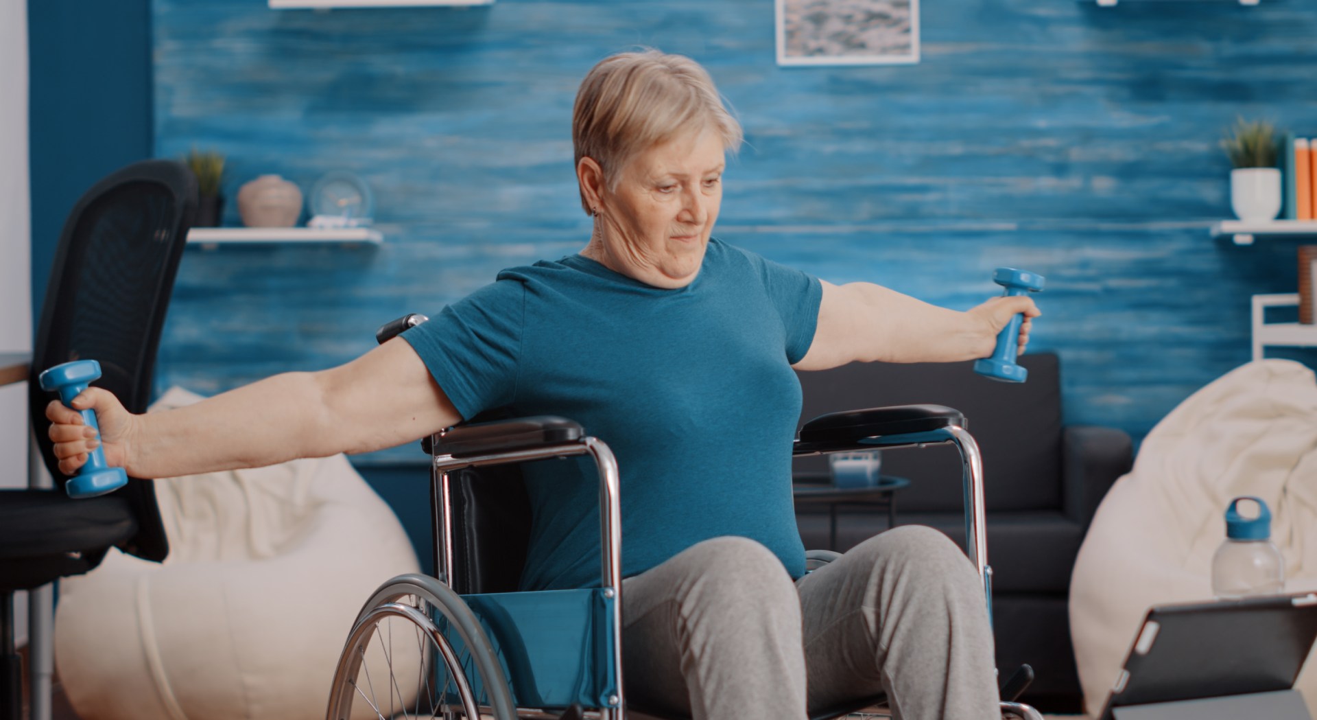 elderly female in wheelchair doing an exercise to support the benefits of physical therapy for alzheimer's dementia