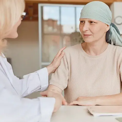 Doctor Supporting Cancer Survivor in Clinic